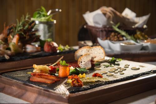 a table with a plate of food on a table at Hotel Villa Magus in Kladnitsa