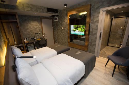 a hotel room with a bed and a television at Emens hotel in Izmir