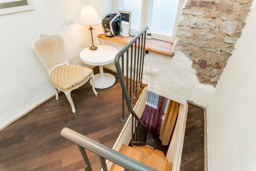 a staircase with a table and a chair and a desk at Meriton Old Town Garden Hotel in Tallinn