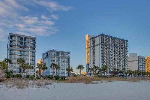two tall buildings on a beach with palm trees at 11-th Floor OcenView w Balcony cozy condo at Boardwalk Resort in Myrtle Beach