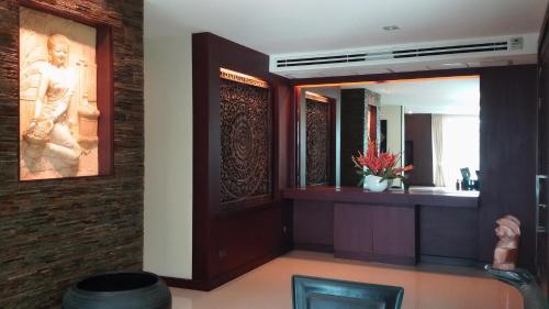 a bathroom with a large mirror and a sink at Karon Suite Apartment in Karon Beach
