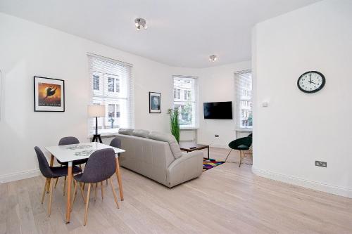 a living room with a couch and a table at Interlude House B by City Living London in London