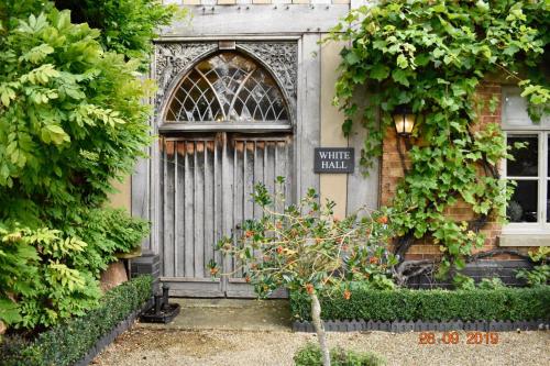 a door of a house with a sign on it at White Hall Farm in Leamington Spa