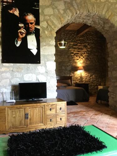 a living room with a tv on a wooden cabinet at La Portella in Oppido Lucano