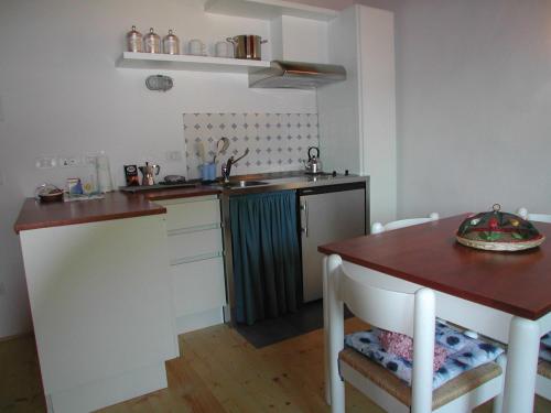 a small kitchen with a table and a sink at Il Pezzatino in Rufina