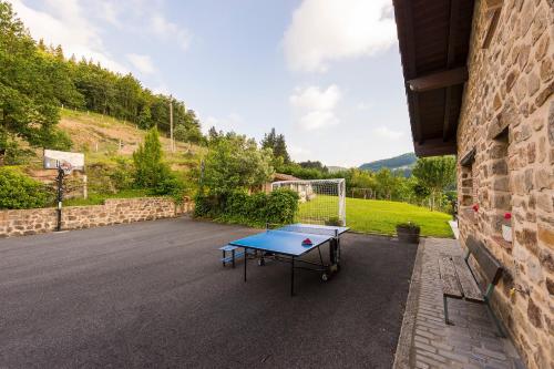 a ping pong table in the middle of a parking lot at Gorosarri in Escoriaza