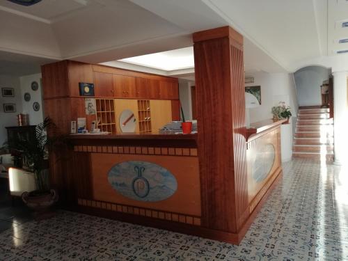 a room with a kitchen with a counter and a staircase at Hotel La Primavera in Massa Lubrense