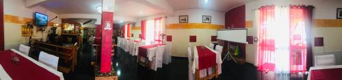a bathroom with red and white walls and a room at Petite Flower Guest House in Talata-maty