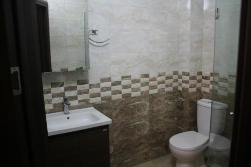 a bathroom with a toilet and a sink at MELINI Boutique Hotel in Batumi