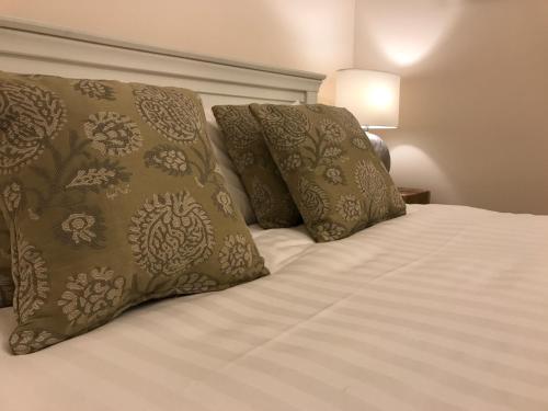 a bed with two pillows on top of it at Stracey Road Apartment in Norwich