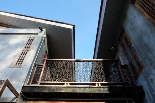 an open door on a building with a balcony at House Of Passion Amphawa in Amphawa
