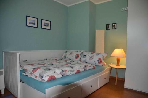 a bedroom with a bed and a table with a lamp at Ferienwohnung Biedermann in Schönwald