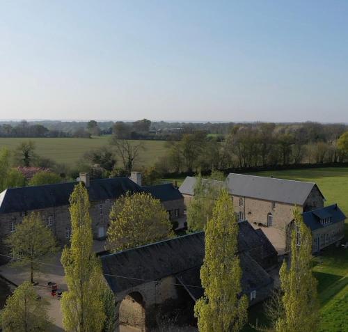 an aerial view of a building in a field at Les Rochers in Cerisy-la-Forêt