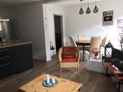 a living room with a table and a dining room at À La Cour de Ribeauvillé avec garage in Ribeauvillé