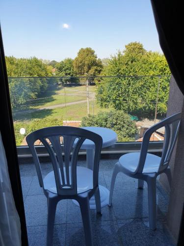 two chairs and a table sitting on a balcony at Family Hotel Novel City in Burgas
