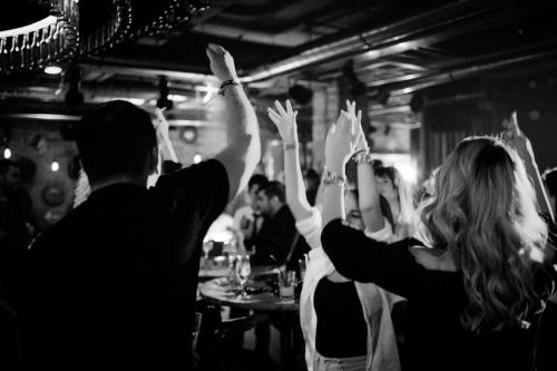 a group of people with their hands in the air at C Guest House in Drobeta-Turnu Severin