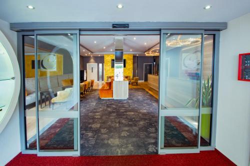 a room with glass doors and a red carpet at Caravelle Hotel im Park in Bad Kreuznach