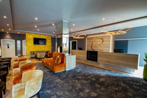 a lobby with couches and chairs in a building at Caravelle Hotel im Park in Bad Kreuznach