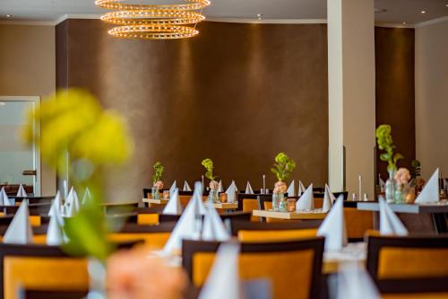 a dining room with tables with laptops on them at Caravelle Hotel im Park in Bad Kreuznach