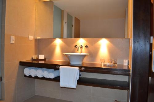 a bathroom with a sink and a mirror at Loi Suites Chapelco Hotel in San Martín de los Andes