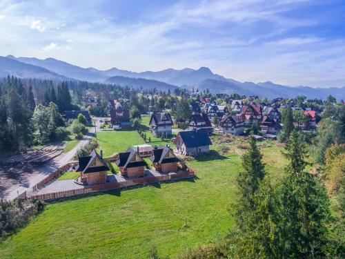 an aerial view of a village with mountains in the background at Osada Podrazówka in Zakopane