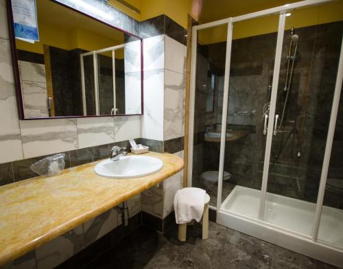 a bathroom with a sink and a shower at Grand Hotel Tamerici & Principe in Montecatini Terme