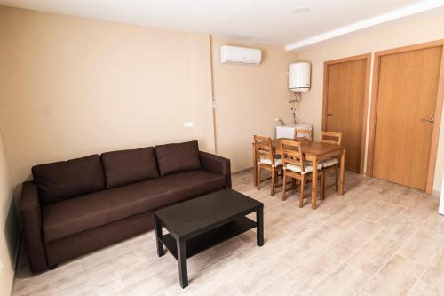 a living room with a couch and a table at CASA CAL METGE in Benissanet