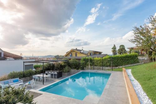 a swimming pool in the backyard of a house at Villa Anna, Luxury and private pool in Alba