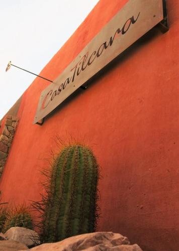 a cactus painted on the side of a red wall at Casatilcara Cabañas in Tilcara