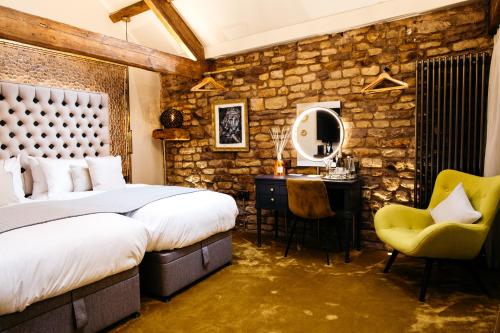 a bedroom with a bed and a desk and a chair at Quite Simply French in Lancaster