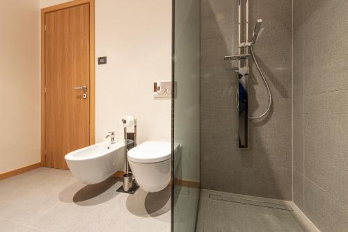 a bathroom with a toilet and a sink and a shower at Villa Anna, Luxury and private pool in Alba