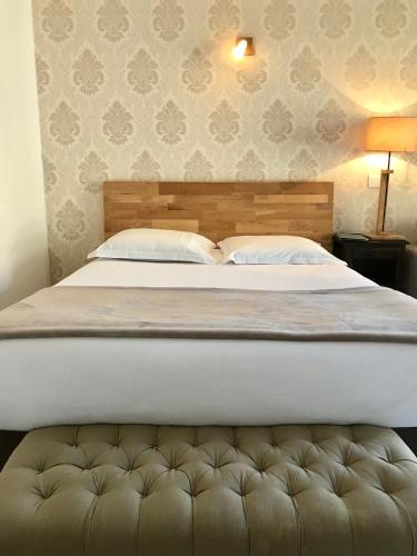 a bedroom with a large bed with a white mattress at Hôtel Le Golfe Ecolabel EU in Porto Ota
