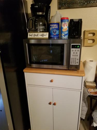 a microwave sitting on top of a white cabinet at Beach More Worry Less in Tampa