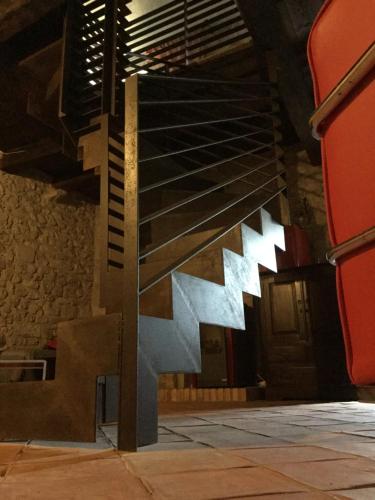 a staircase in a building with red chairs at La Portella in Oppido Lucano