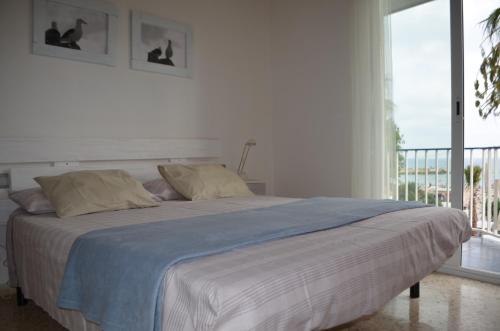 シッチェスにあるSeafront Sitgesの白いベッドルーム(大型ベッド1台、バルコニー付)