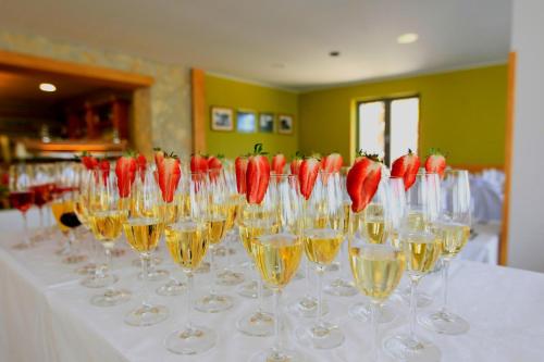 a table with wine glasses with strawberries in them at Hotel Zarja in Pohorje