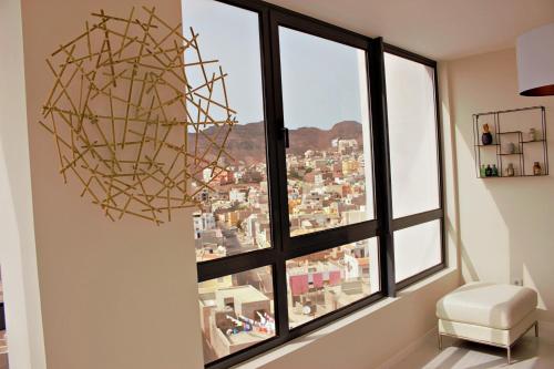 a room with a large window with a large sculpture at Kasa Imbondeiro in Mindelo