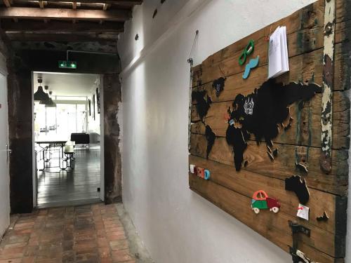a wall with a wooden board with toys on it at Gîte Le Chemin vers l'Etoile in Saint-Jean-Pied-de-Port