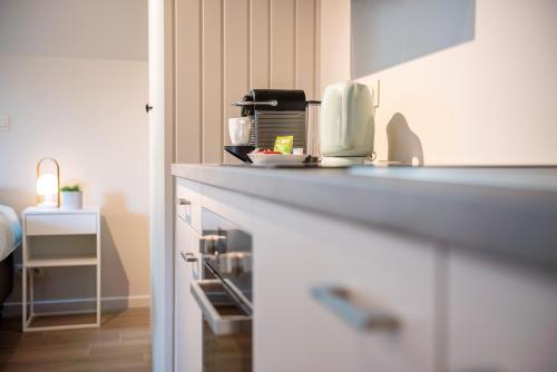 a kitchen counter with a coffee maker on it at B&B Hof Beygaert in Aalst