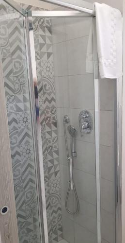 a shower with a glass door and a shower at Casa Maria in Modica