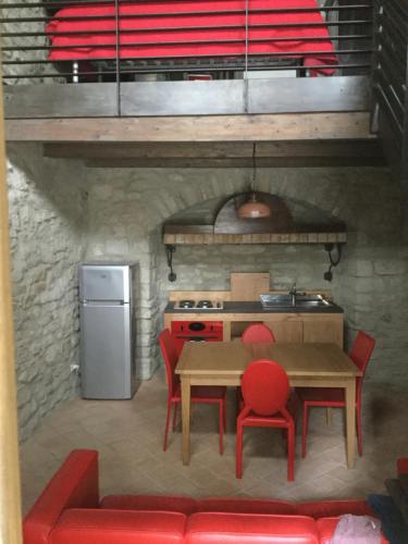 a kitchen with a table and chairs and a stove at La Portella in Oppido Lucano
