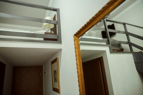 a mirror on a wall next to a room at Tea for Two Hotel in Tbilisi City