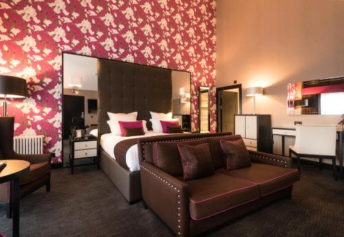 a hotel room with a bed and a couch at Fonab Castle Hotel in Pitlochry