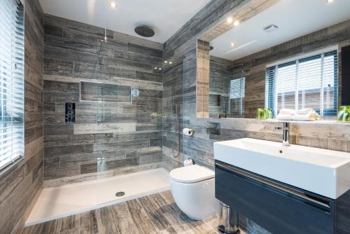 a bathroom with a tub and a toilet and a sink at Fonab Castle Hotel in Pitlochry