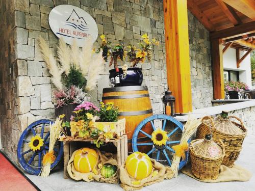 a display of fruits and vegetables in baskets and a barrel at Hotel Alpenblick-Leukerbad-Therme in Leukerbad