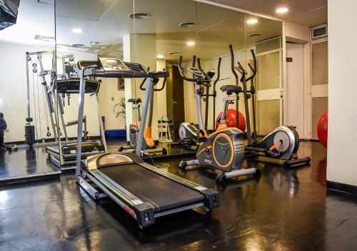 a gym with several treadmills and cardio machines at Park Royal City Buenos Aires in Buenos Aires