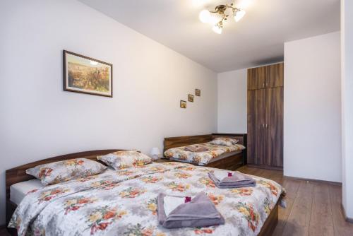 a bedroom with two beds and a closet at Trapezitsa Apartment - free parking in Veliko Tŭrnovo