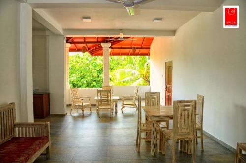 a dining room with a table and chairs at Villa Red Lobster in Hikkaduwa