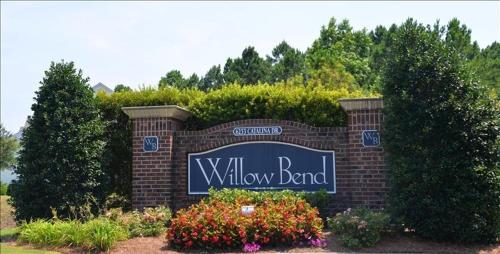a sign for a willow bend sign on a brick wall at 1515 Willow Bend Condo in North Myrtle Beach