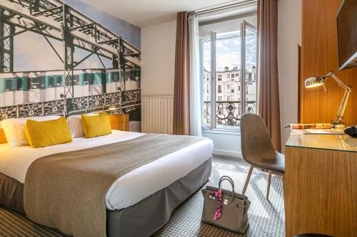 a hotel room with a bed and a window at Le 20 Prieuré Hôtel in Paris